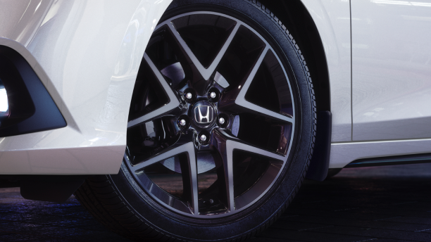Closeup of wheel on a white Hatchback.