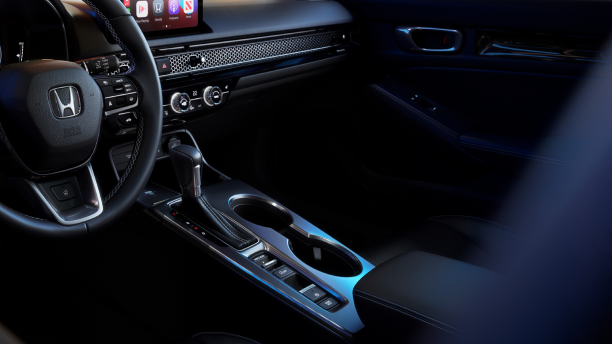 Closeup of gear shifter and cupholder console. 