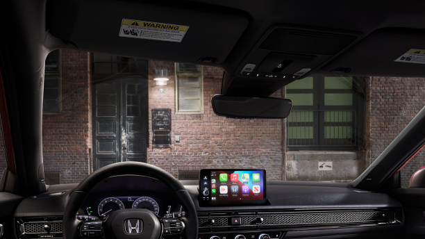 Interior panoramic view of the windshield on a Hatchback parked in front of brick wall in an old warehouse district.