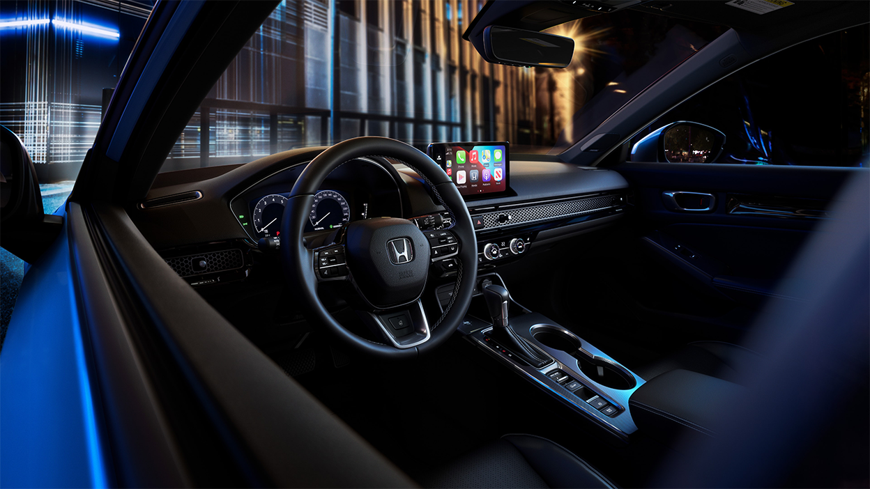 Closeup of steering wheel, looking in through the driver-side window.