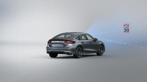 3/4 rear view of grey Civic Hatchback. Blue sensor waves and lines emit from the front, detecting a traffic sign. 