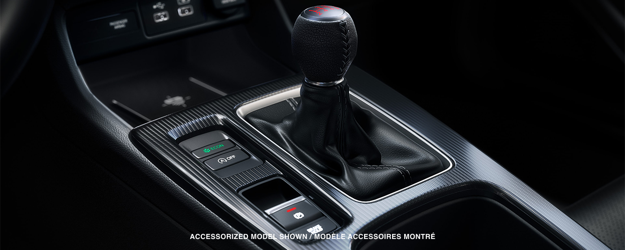 Closeup of six speed manual transmission gear shifter.