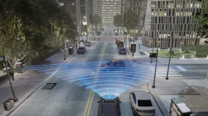 3/4 rear bird’s eye view of grey CR-V nearing a “T”, as a car turns in front of it. Blue sensor waves and lines emit from the front. 