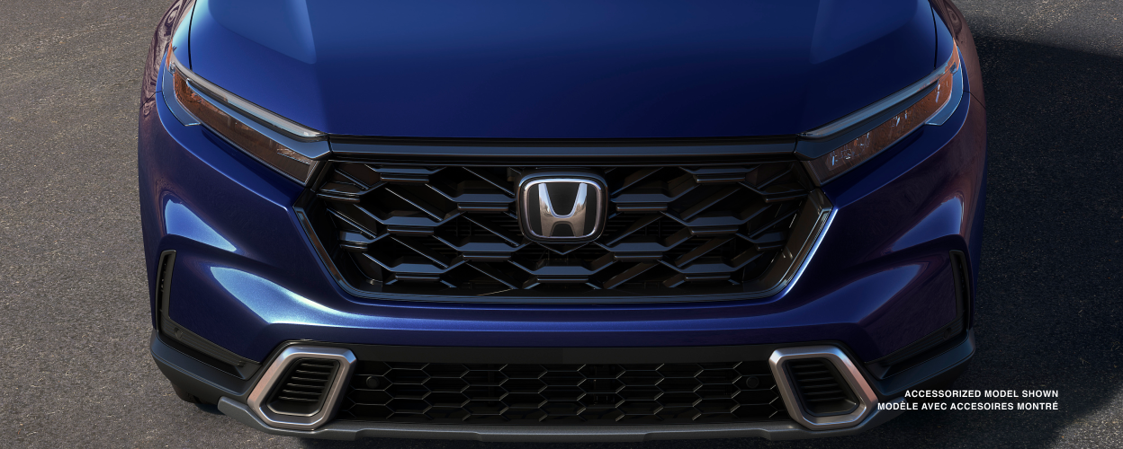 3/4 front bird’s eye view of honeycomb grille on a blue CR-V.