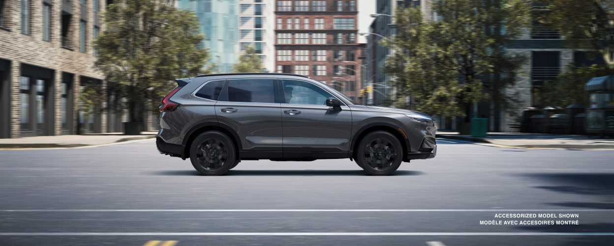 Sideview of grey CR-V driving in the city.