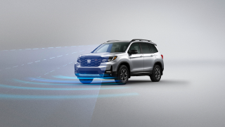 3/4 front view of grey Passport. Blue sensor waves and lines emit from the front.