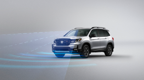 3/4 front view of grey Passport. Blue sensor waves and lines emit from the front.