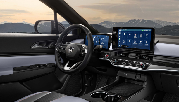 3/4 panoramic interior view of dashboard and new centre console. Out the windshield we see snowy mountaintops.