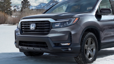 3/4 front view of grey Ridgeline in the snowy outdoors.
