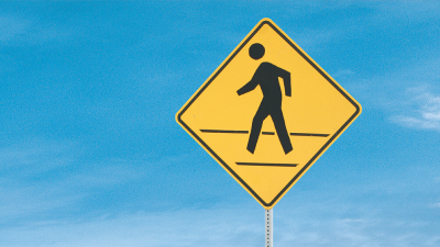 Closeup of a crosswalk sign.