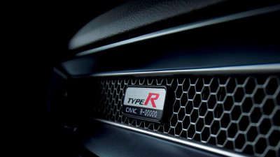 Closeup of Type R serial number plate on the honeycomb vent on the front passenger dashboard.