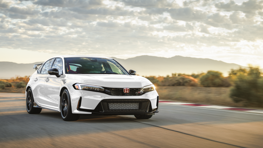 3/4 front view of white Type R racing on a track.