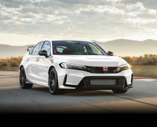 3/4 front view of white Type R racing on a track.