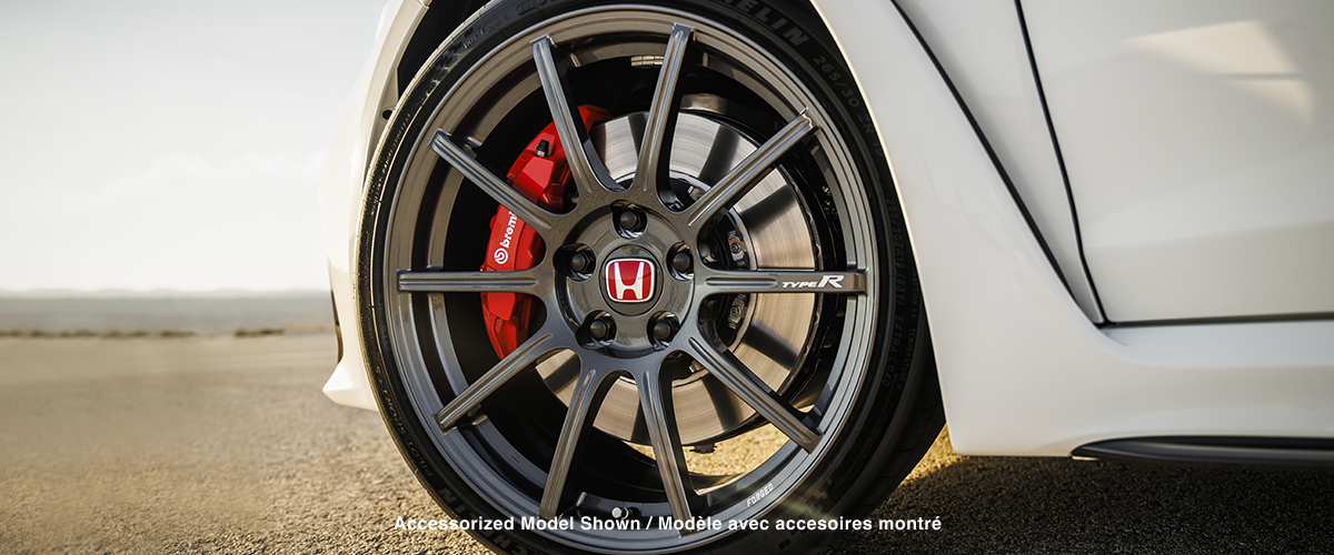 Closeup of wheel on a white Type R; Brembo® caliper is visible.