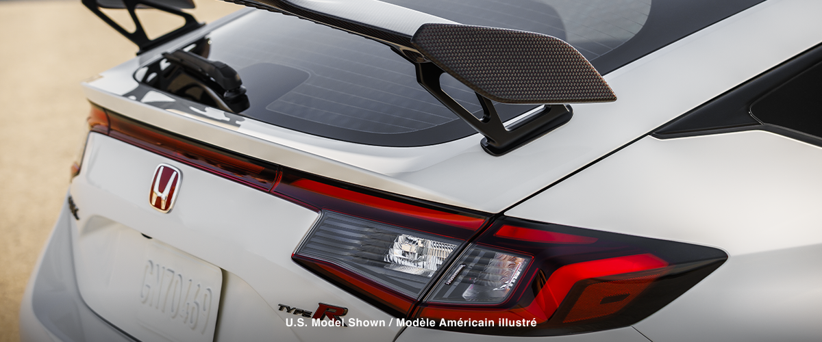 3/4 closeup of white Type R’s rear wing spoiler.