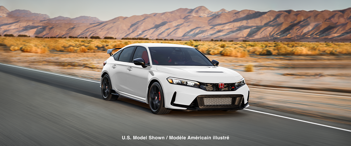3/4 front view of white Type R driving on straight desert highway.